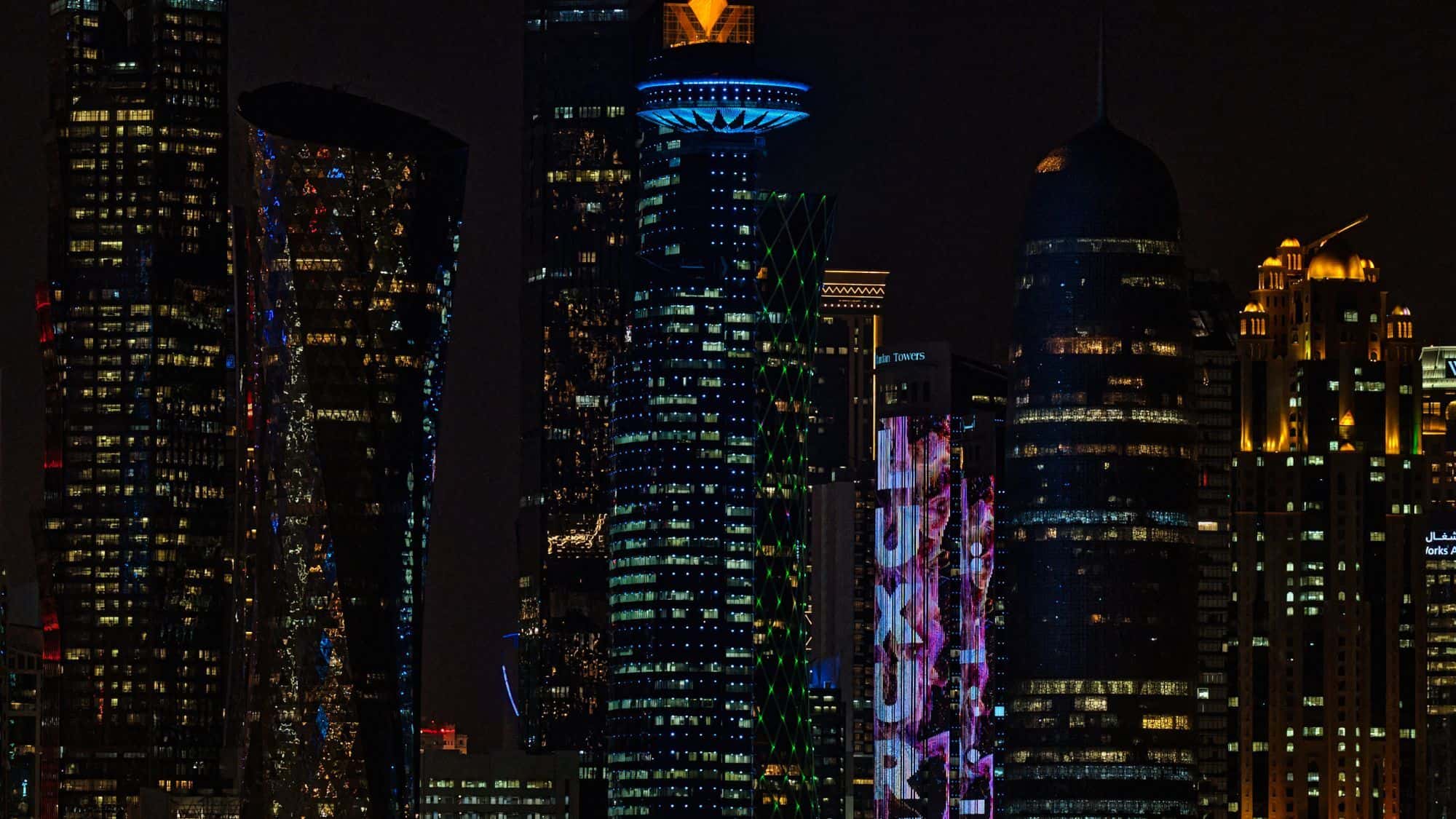 Doha skyline at night representing Gulf businesses budgeting for a chatbot