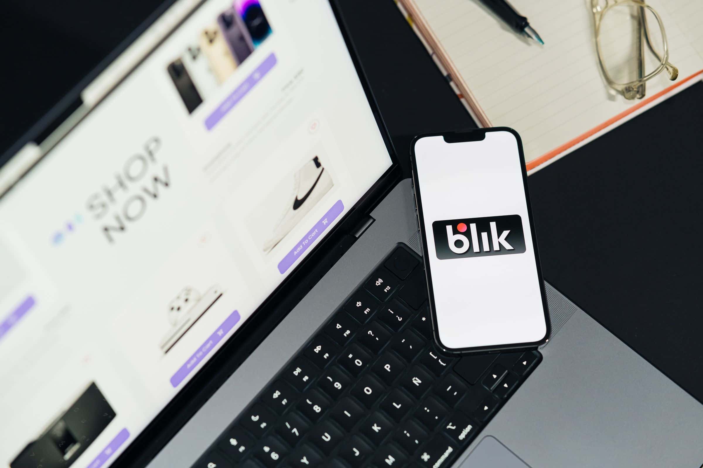 Store owner reviewing an ecommerce interface on a laptop and smartphone