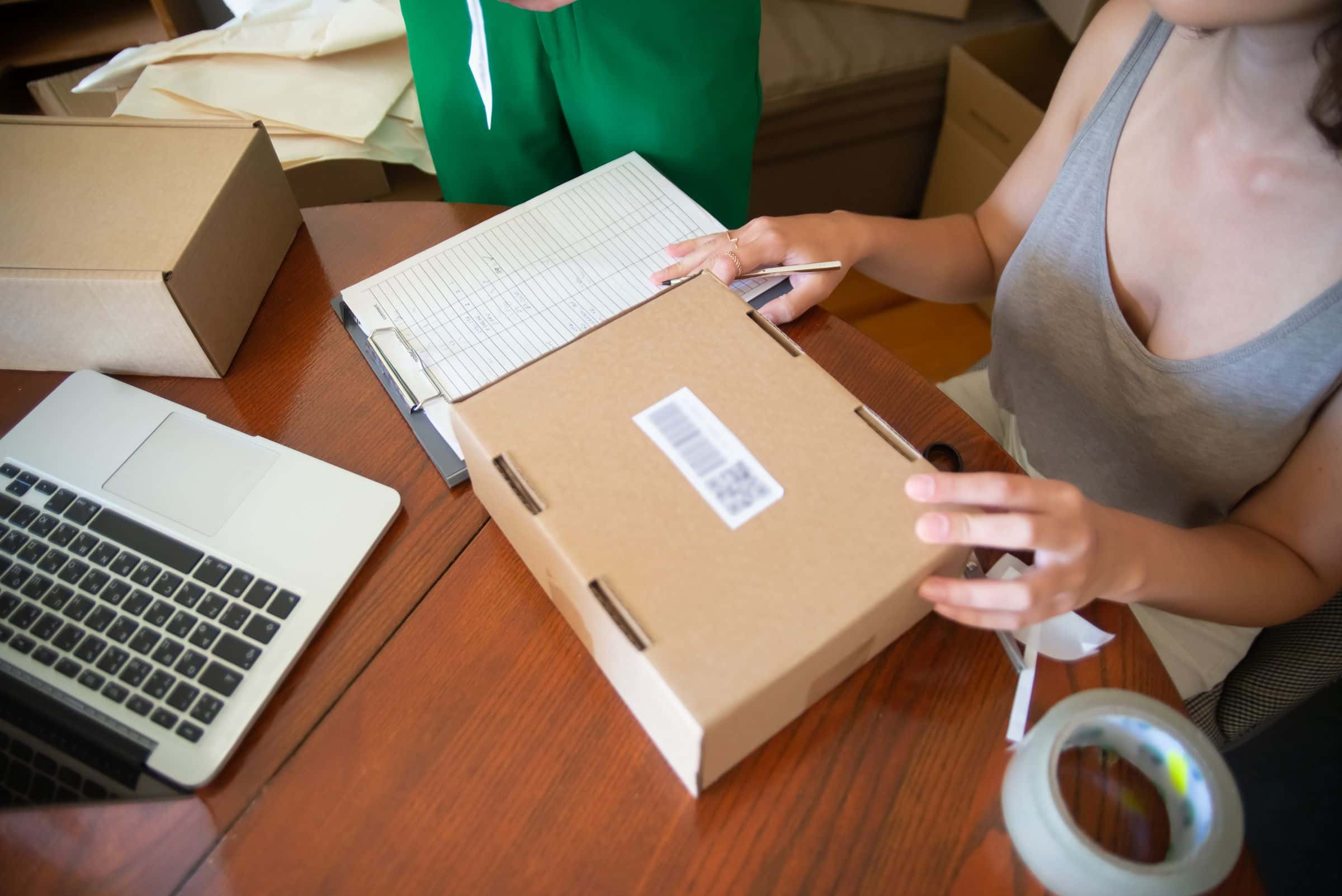 Small-business owner preparing orders for a licensed online store in Oman