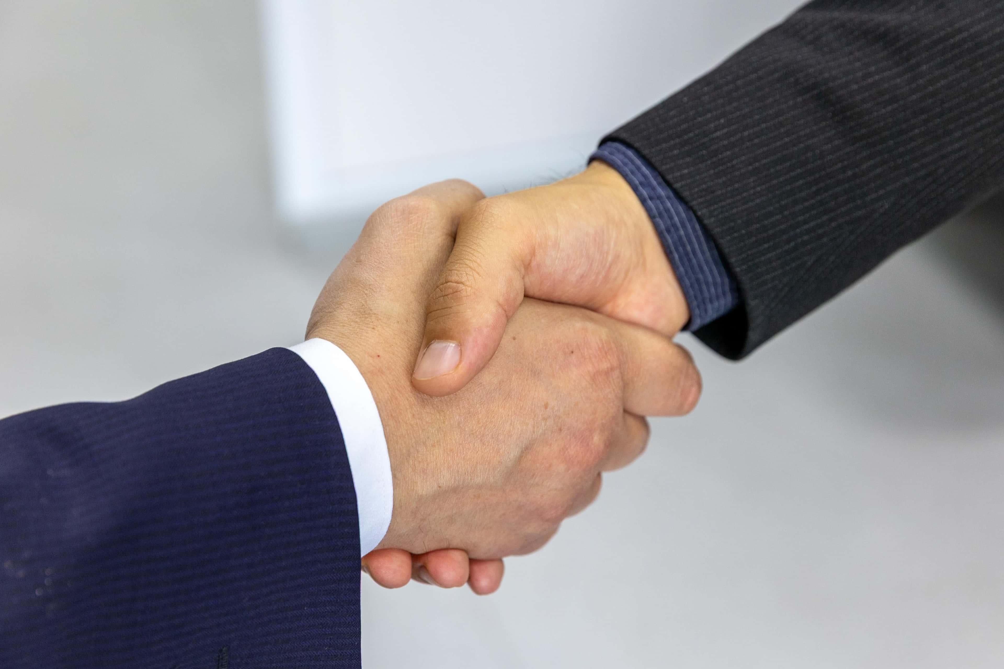 Handshake after reviewing a software project contract and costs