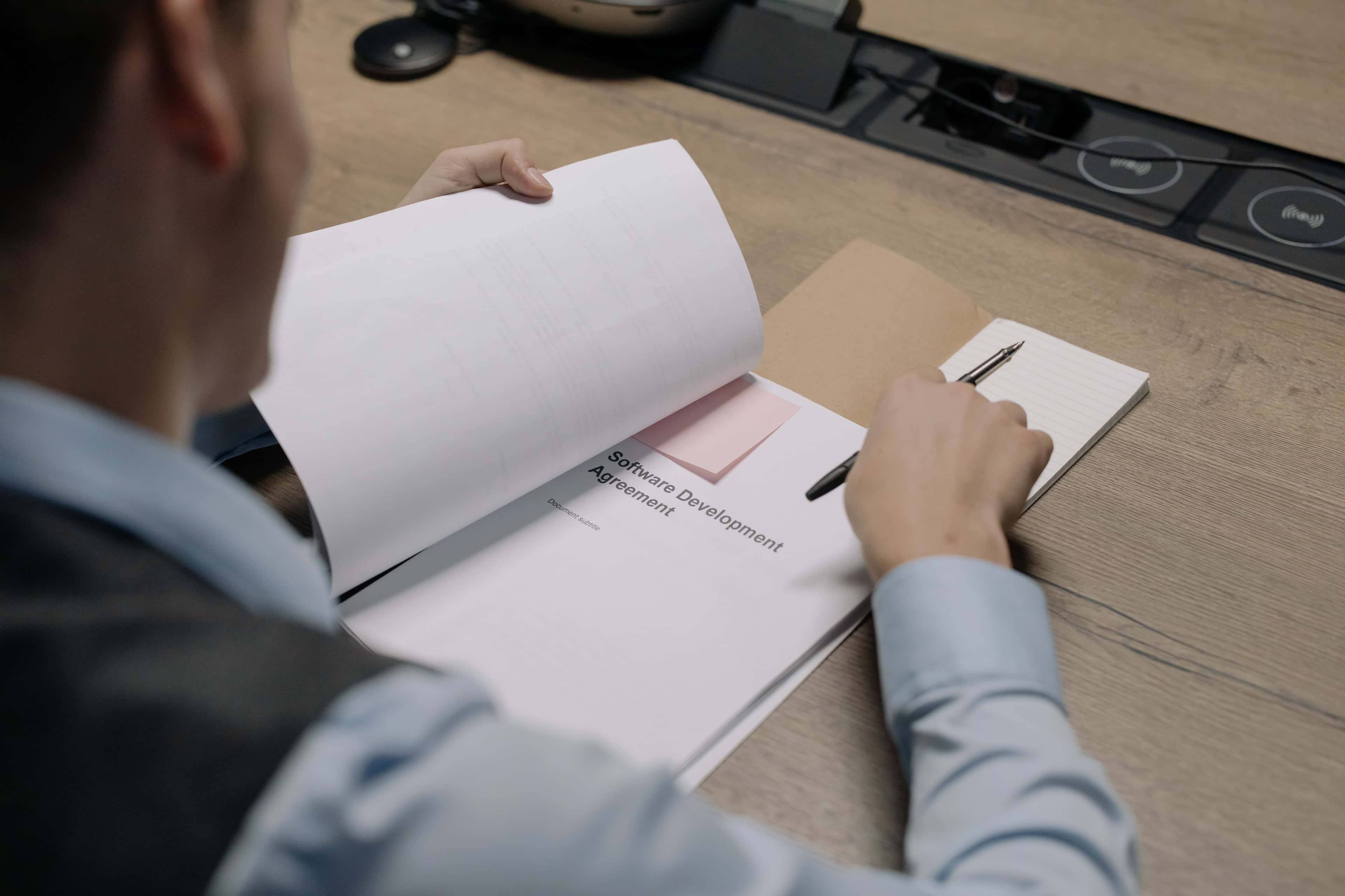 Manager reviewing a software requirements brief before requesting quotes