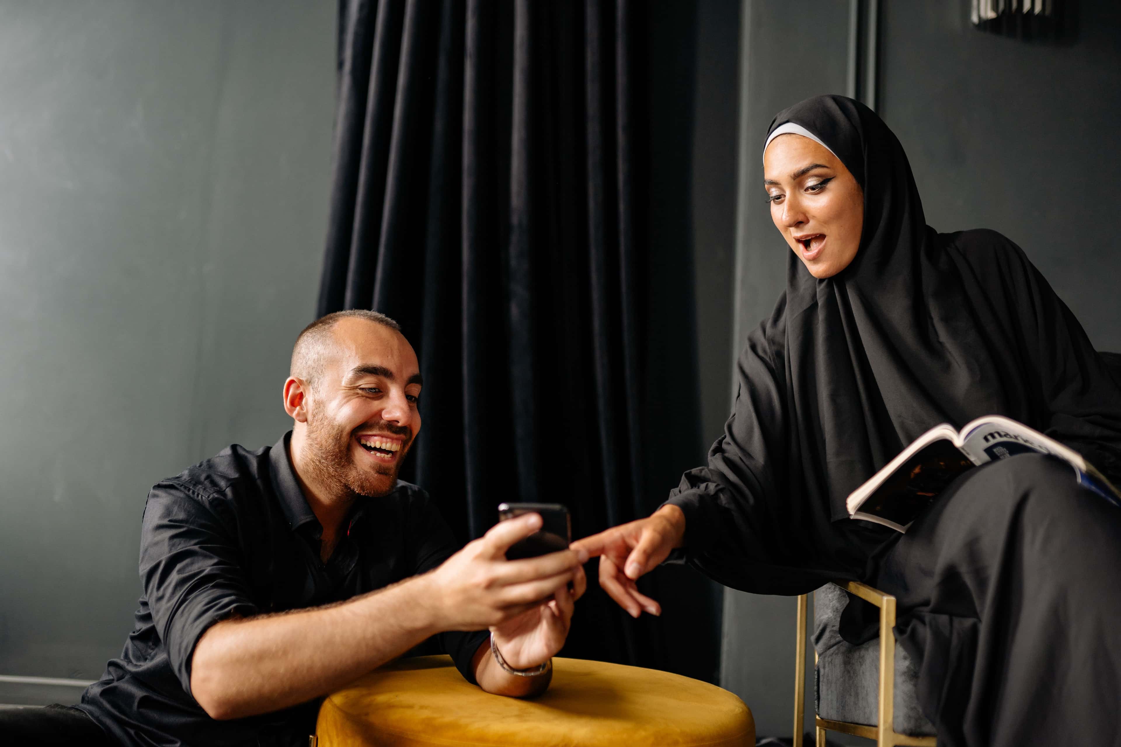 Two users testing an Arabic conversation on a smartphone
