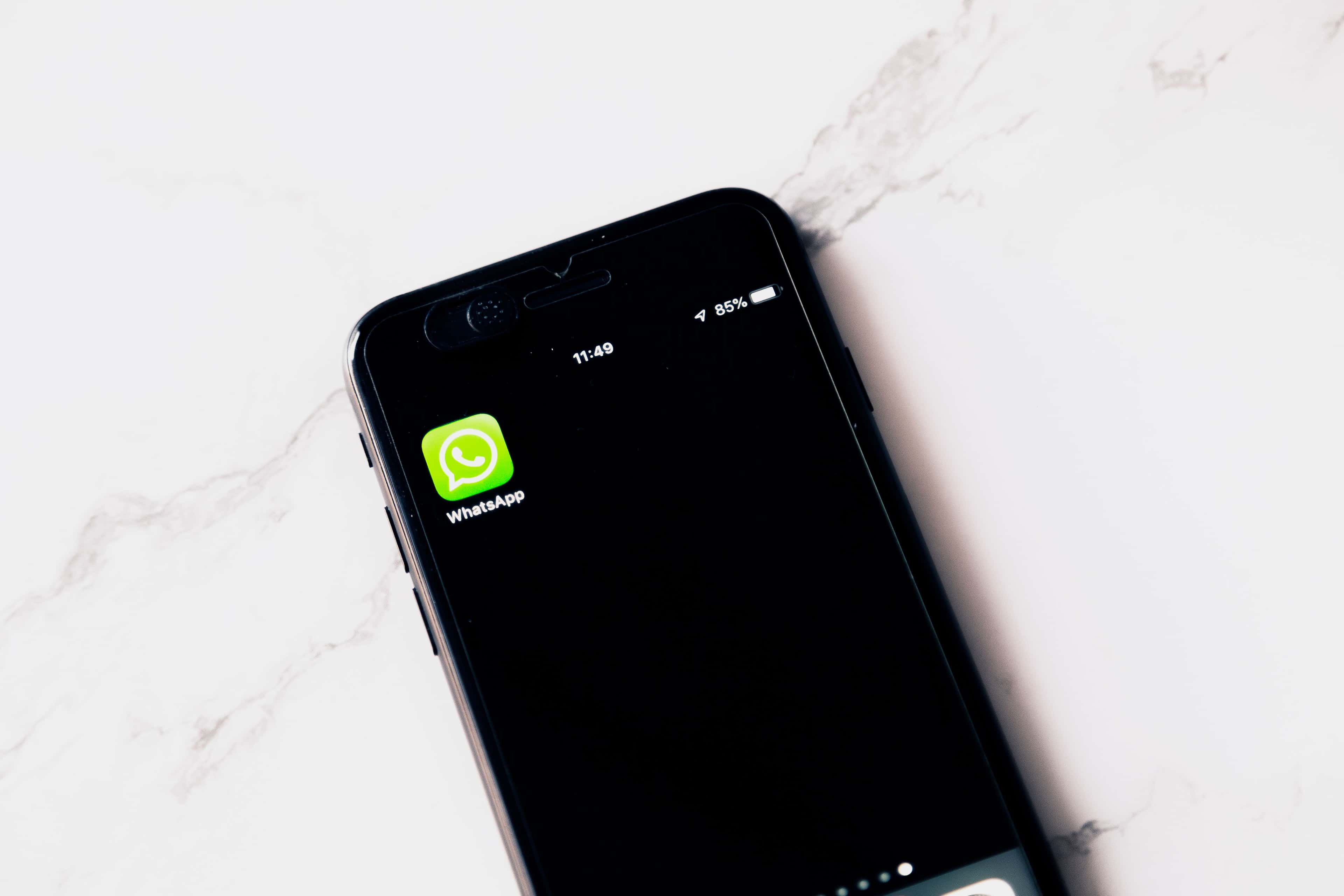 Modern phone showing WhatsApp for planning WhatsApp Business API costs