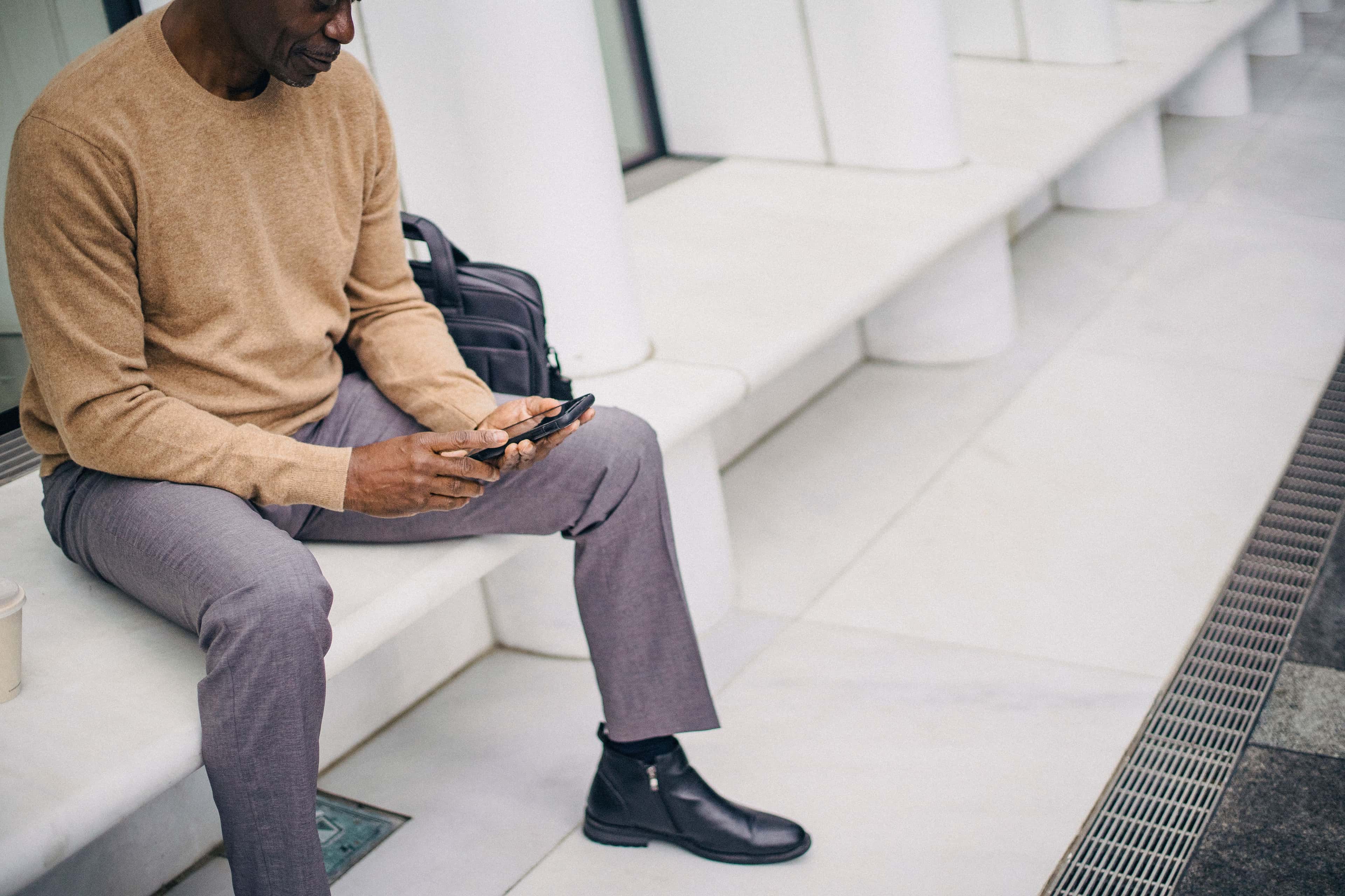 Business professional using a phone in a messaging journey connected to CRM