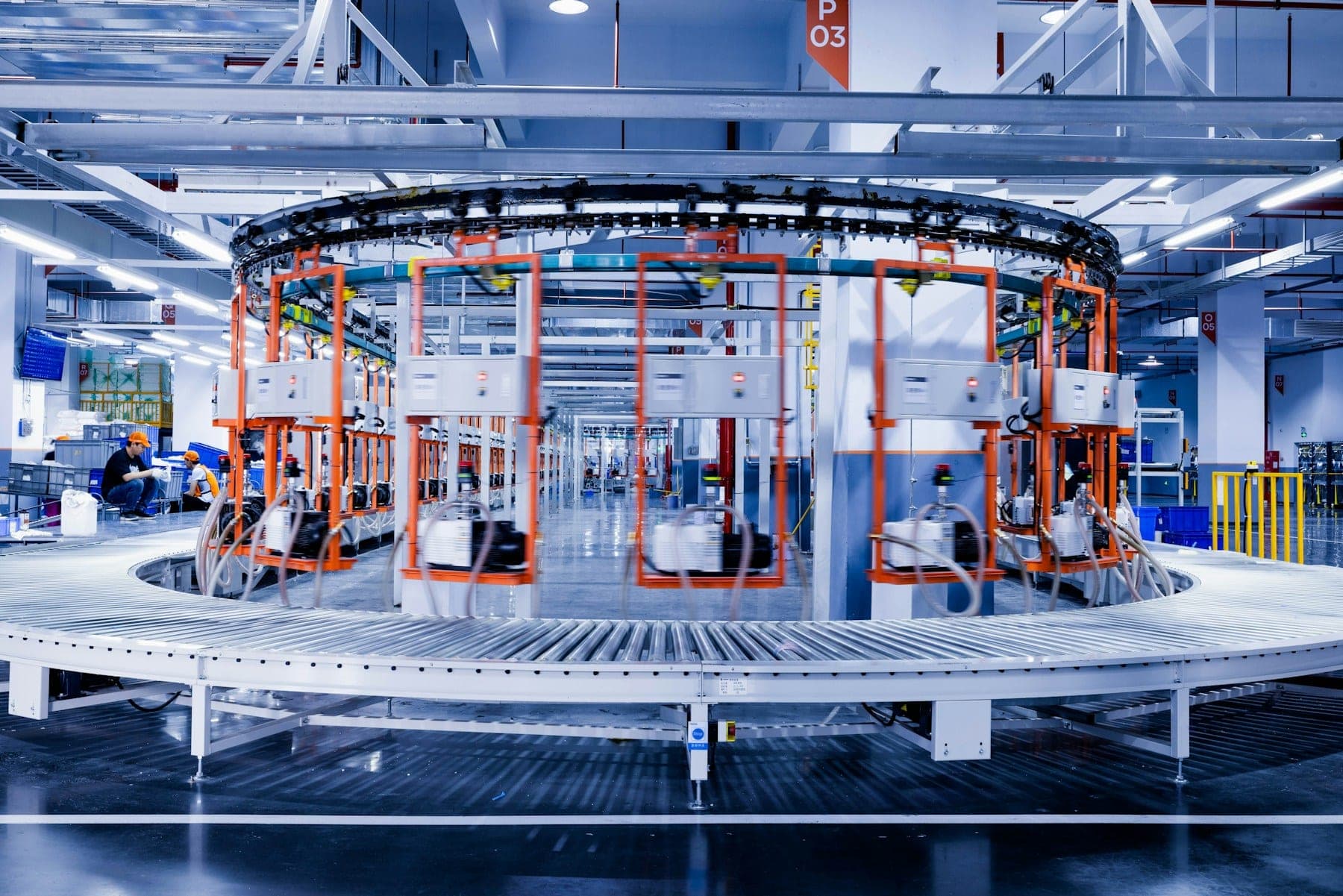 A circular sortation carousel feeding parcels onto a conveyor line in a distribution center.