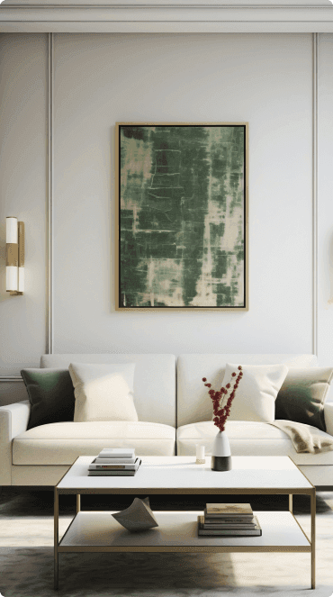 A living room with a cream sofa beneath a large framed abstract painting, a coffee table stacked with books in front of it.