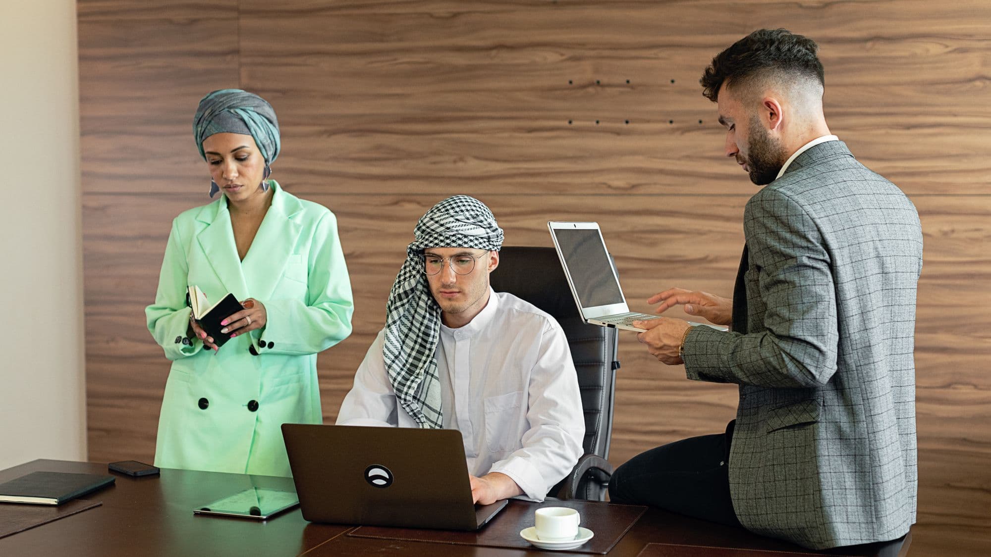 A business team reviewing a digital project with laptops
