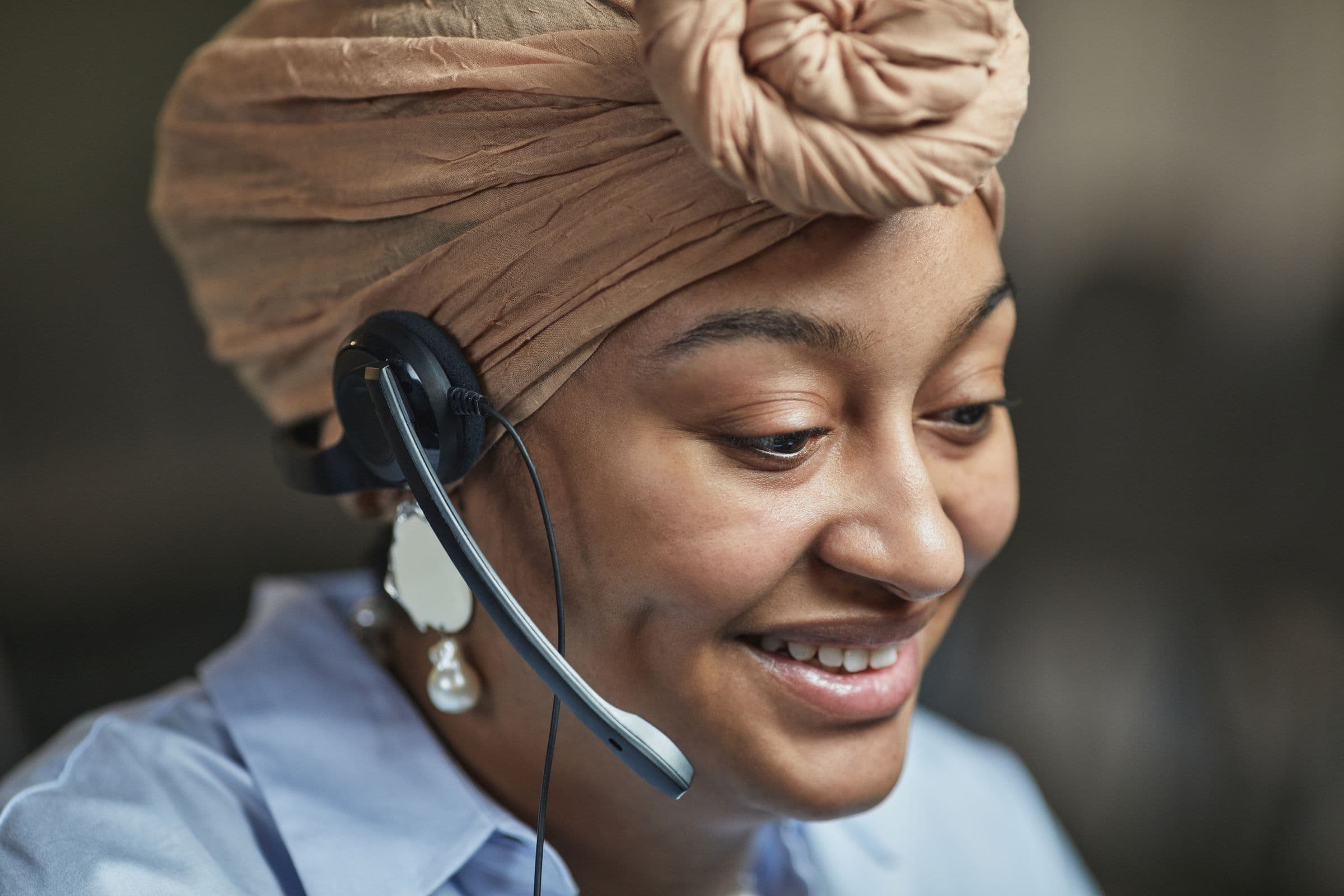 Arab businesswoman using a smartphone and laptop to manage digital customer conversations