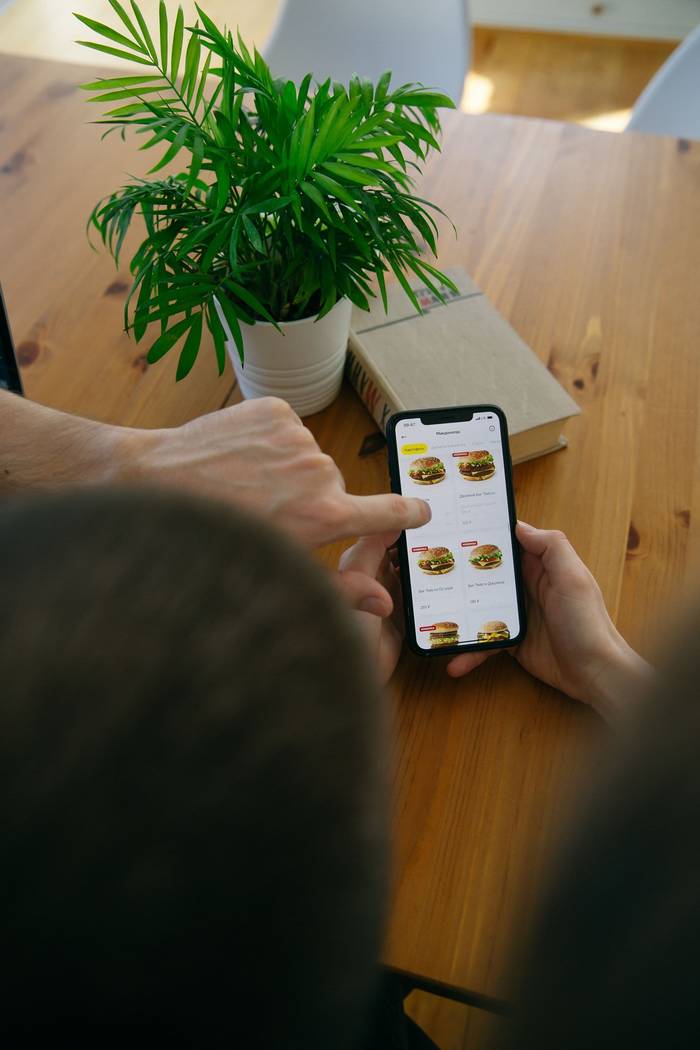 Diners in a Dubai restaurant using smartphones around a table to open a QR menu