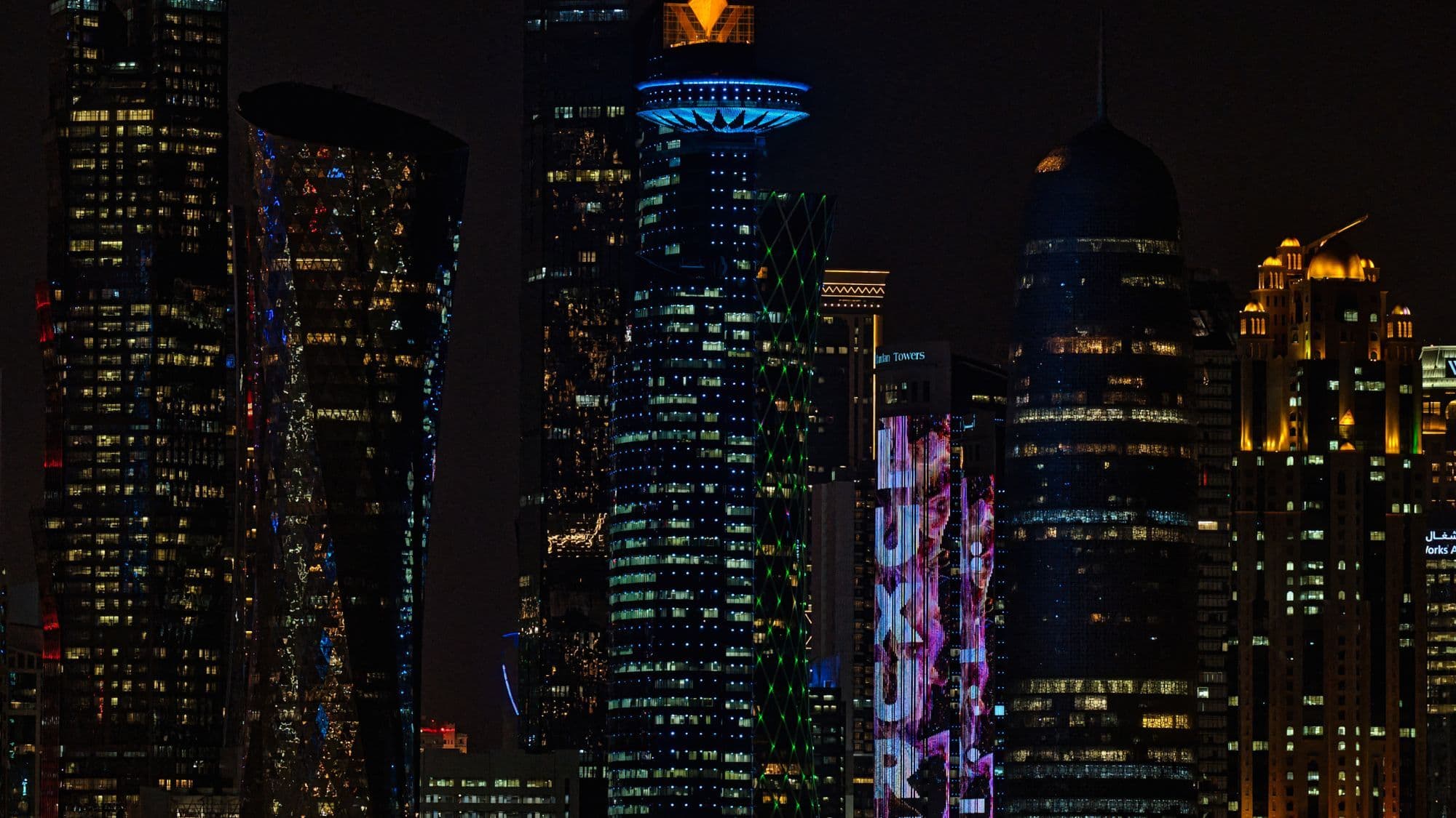 Doha skyline at night representing Gulf businesses budgeting for a chatbot