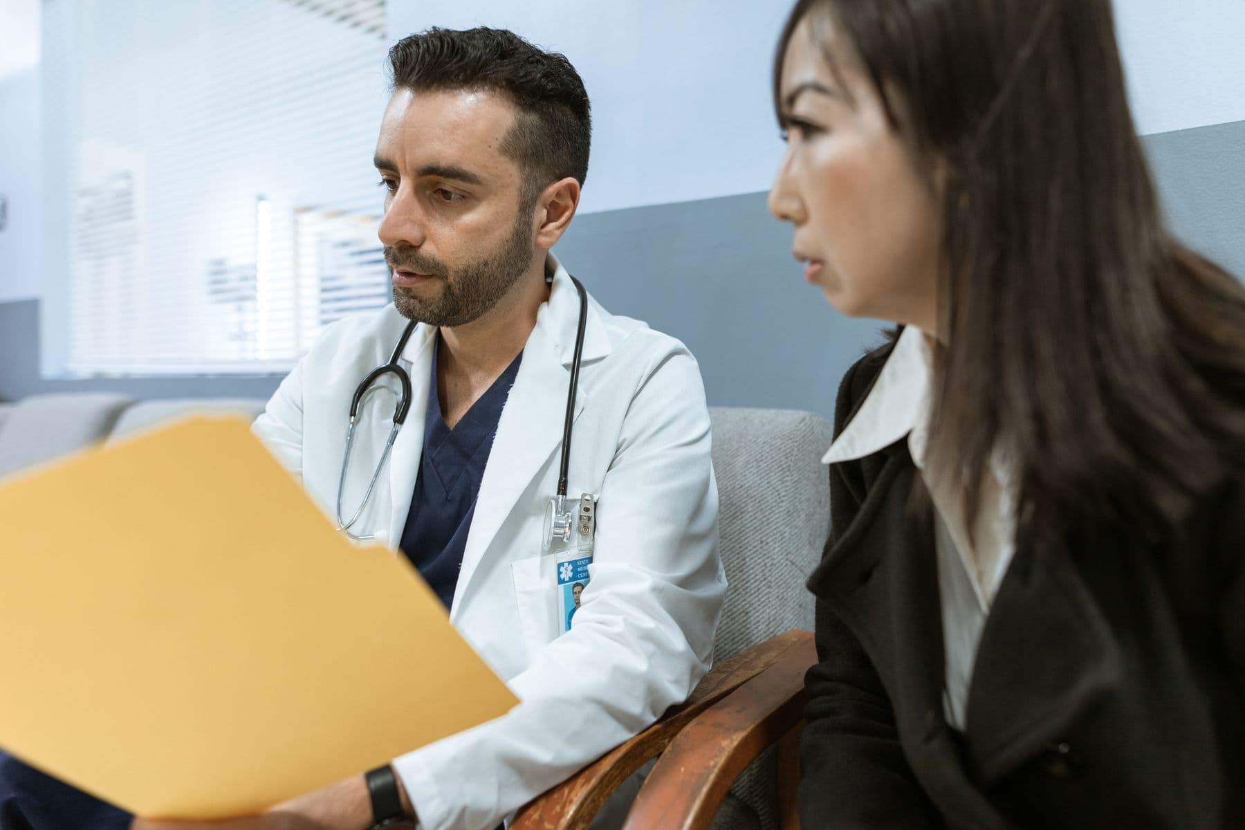 Doctor seeing a patient at a clinic after an online booking