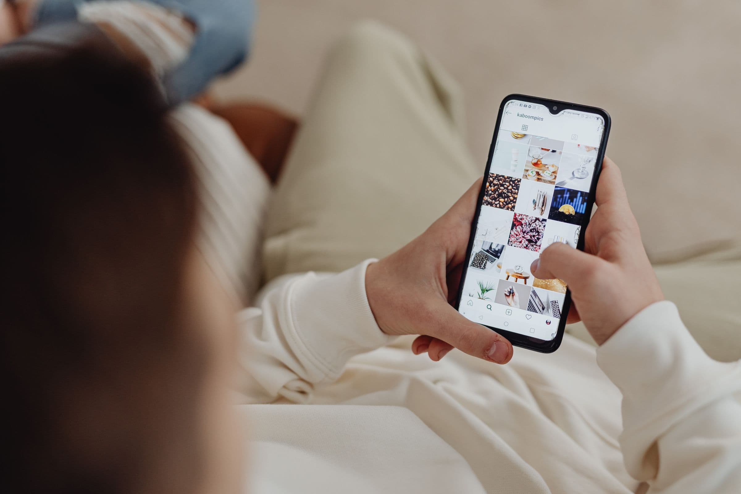 Person browsing Instagram on a phone as an audience channel