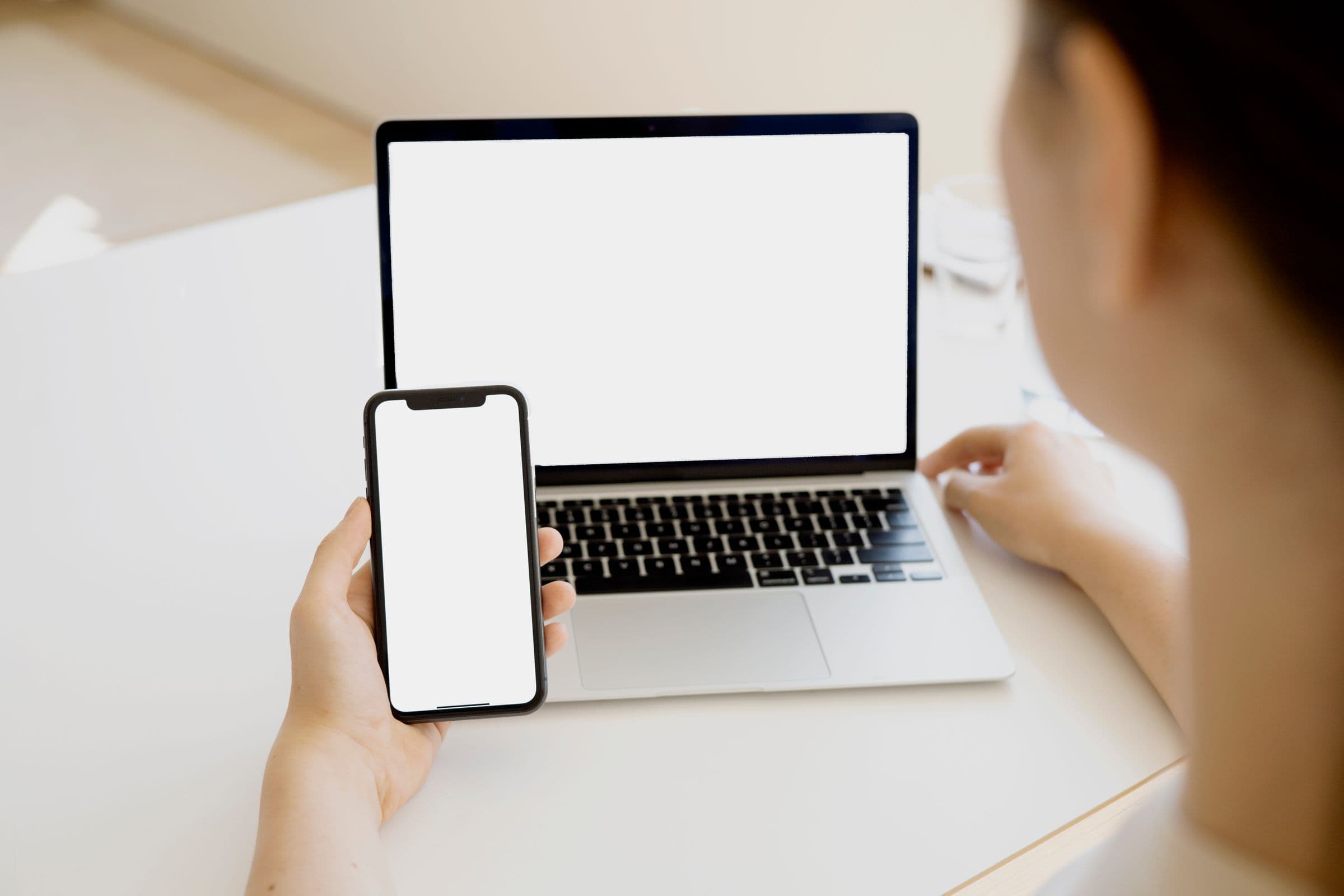 Phone and laptop illustrating movement from social reach to website conversion