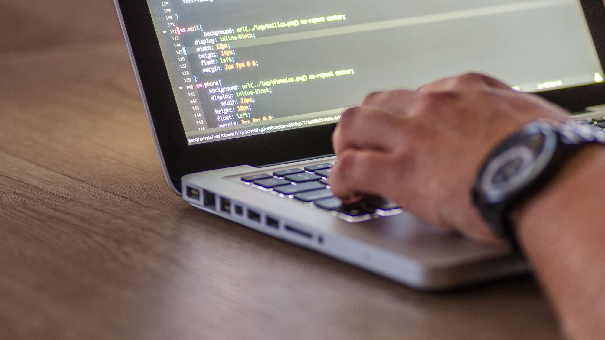 Programming code on a laptop representing testing of custom Odoo modules