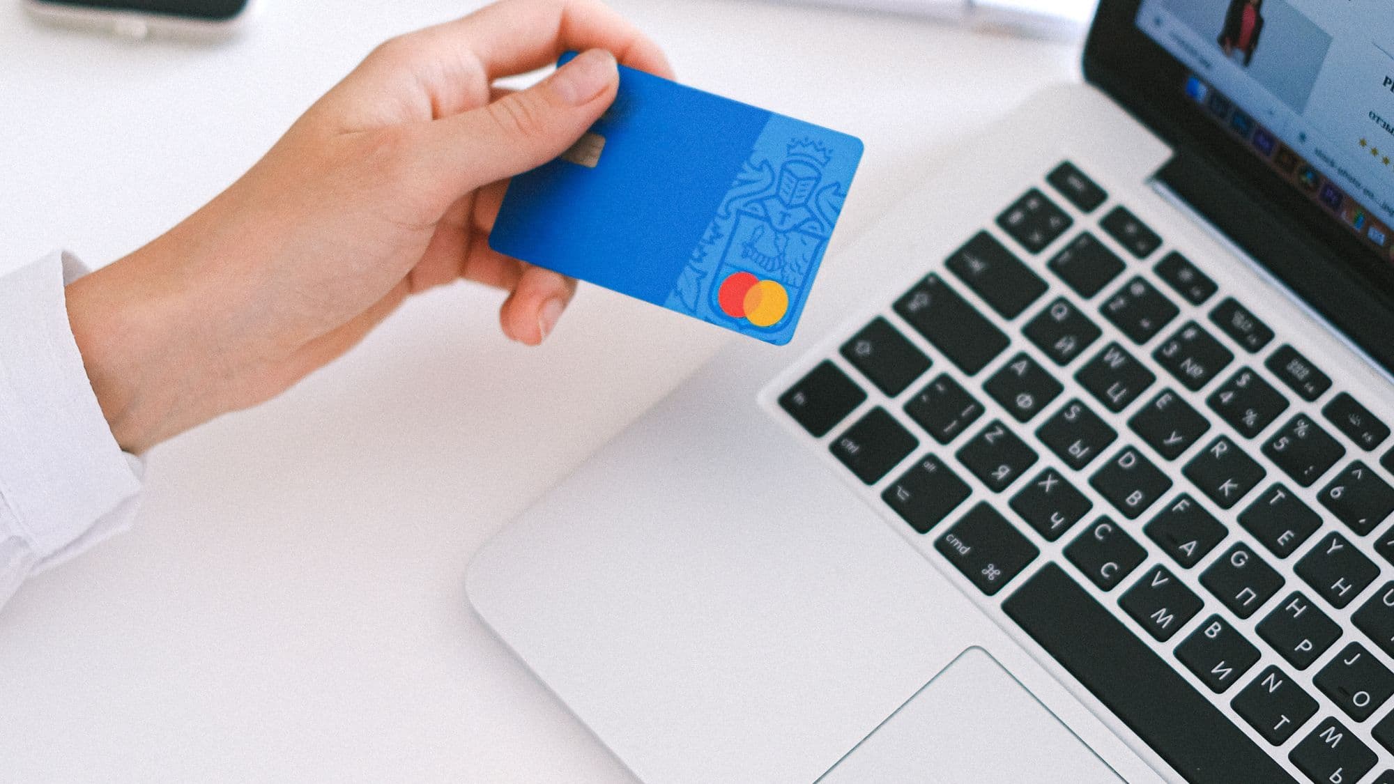 Bank card and laptop used to test an ecommerce payment flow