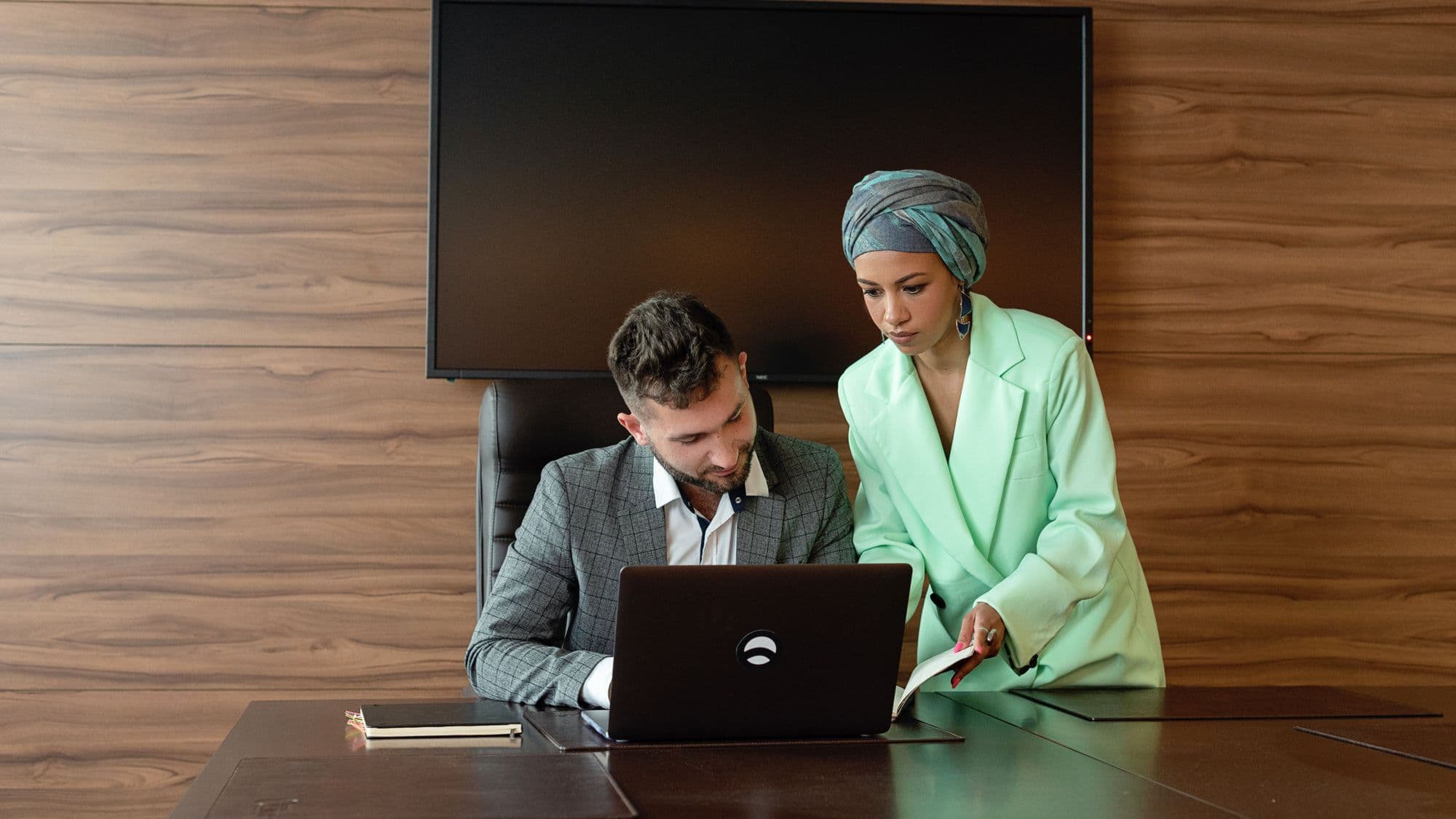 Business team reviewing customer information on a laptop