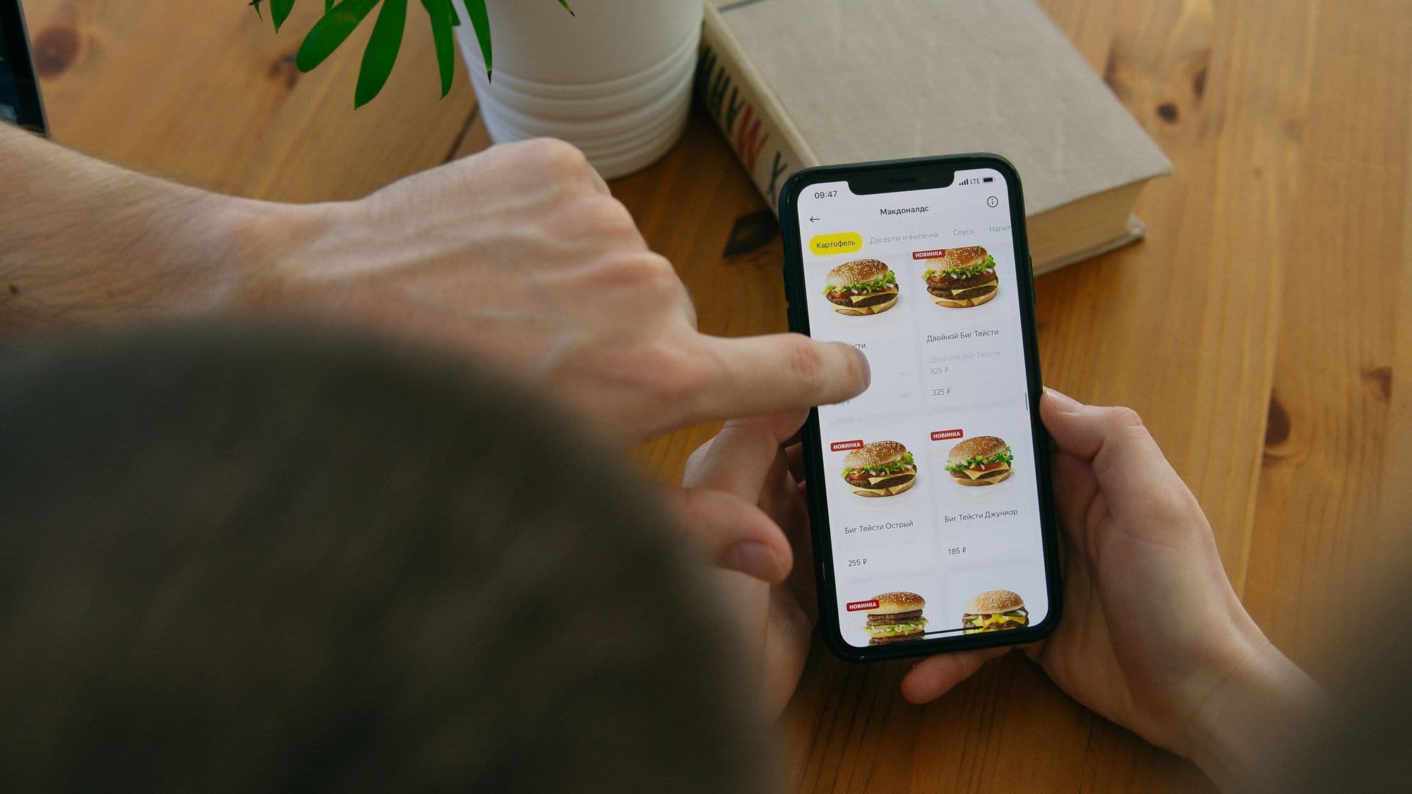 A customer choosing a meal from a digital menu on a phone