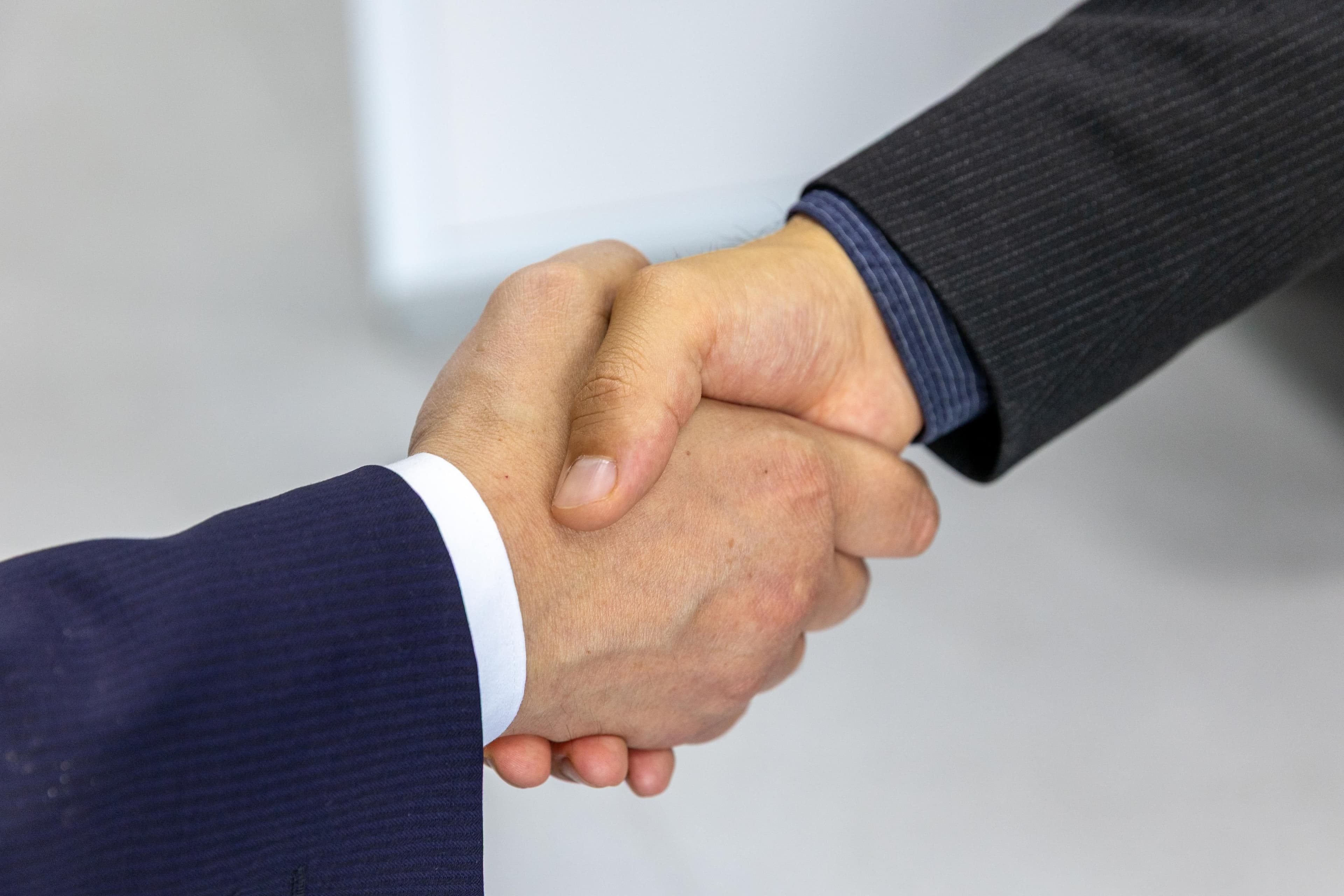 Handshake after reviewing a software project contract and costs