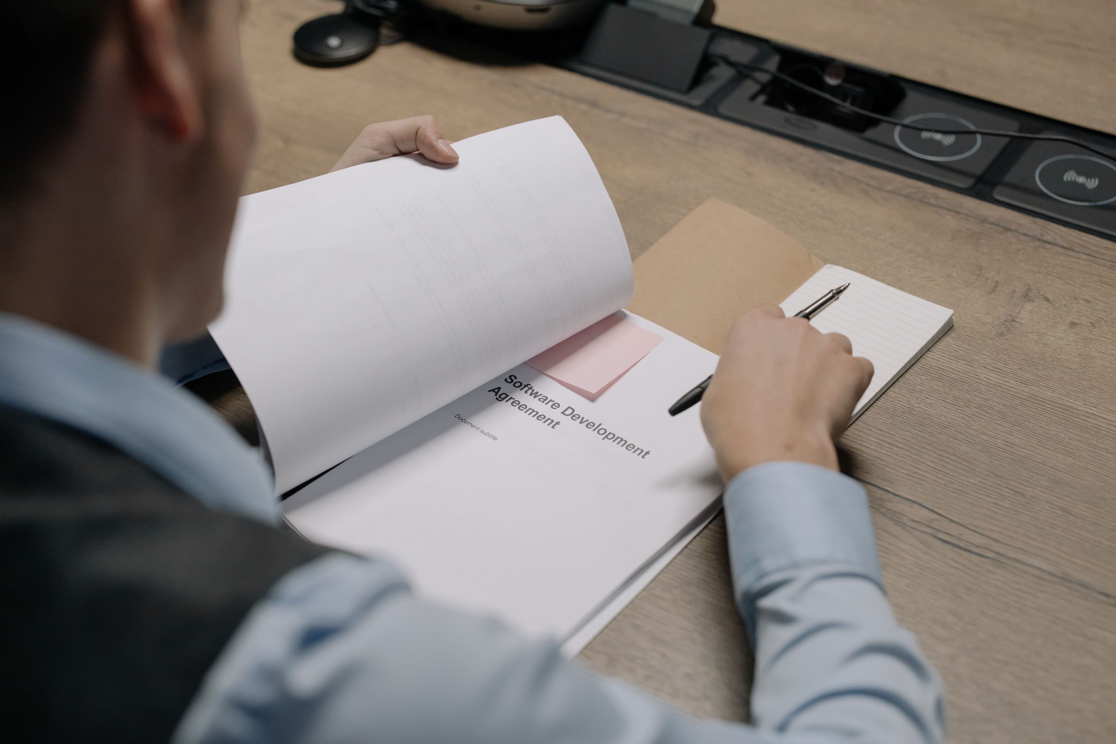 Manager reviewing a software requirements brief before requesting quotes