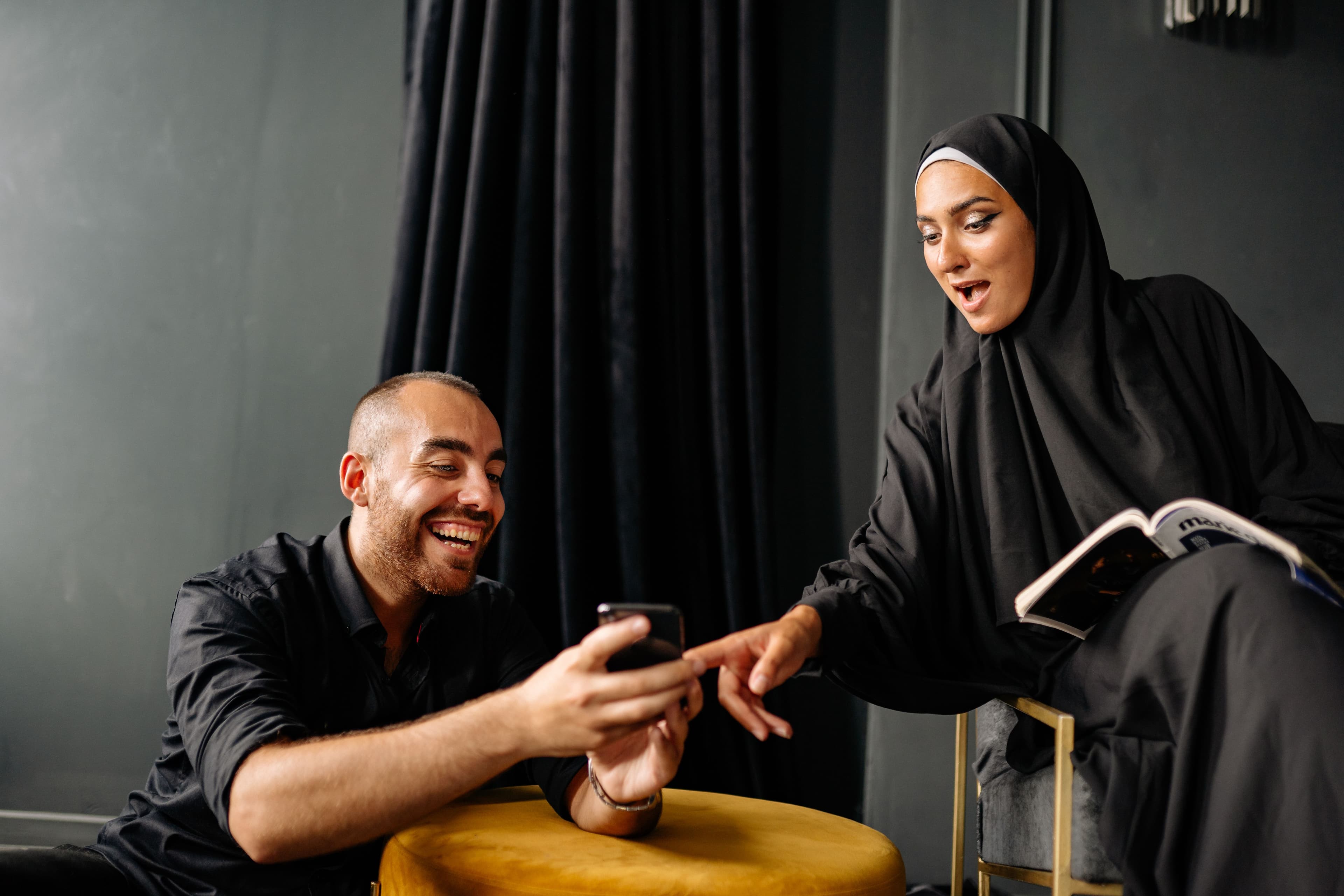 Two users testing an Arabic conversation on a smartphone