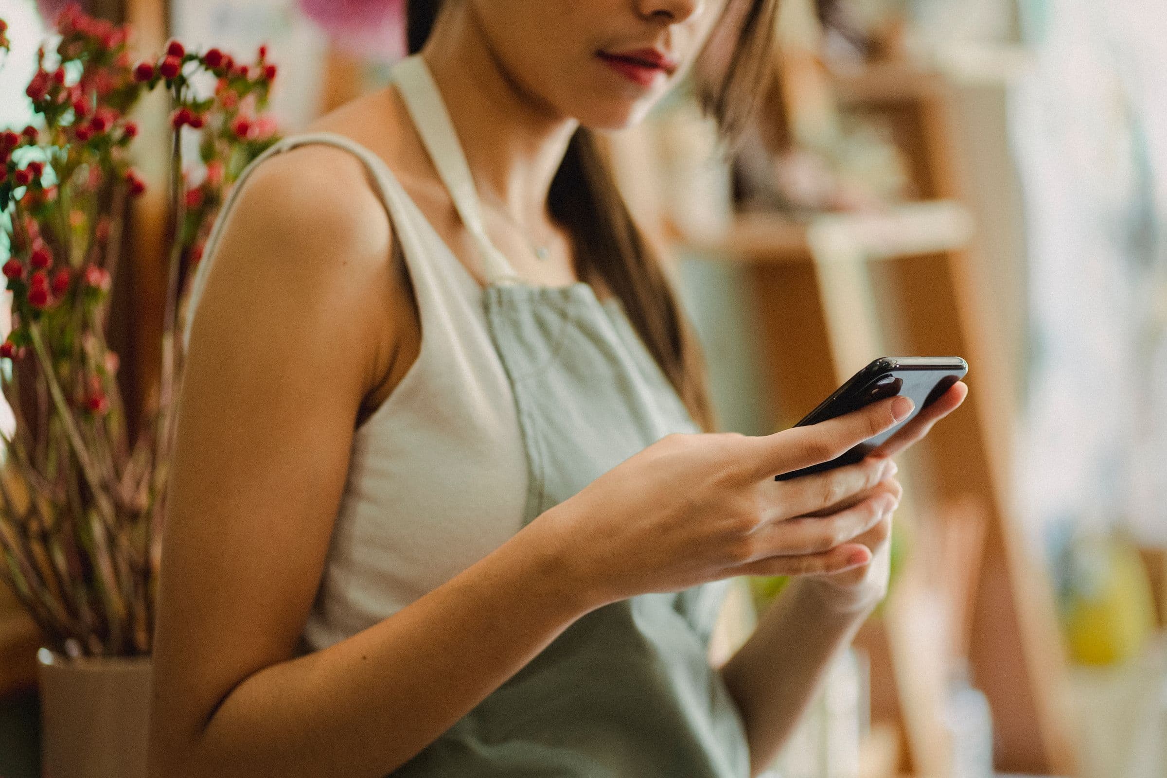 Small business owner using a phone to manage Instagram sales in the UAE