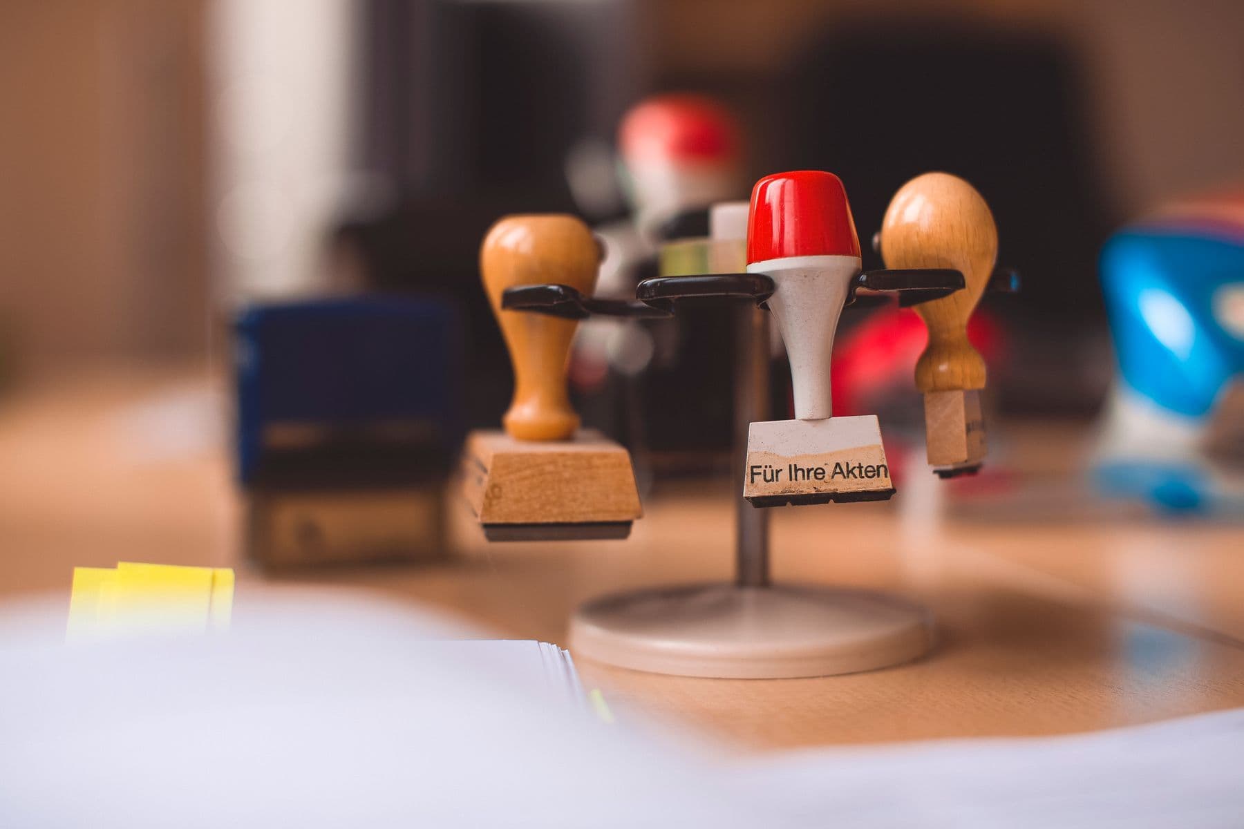 Official documents and a stamp on a desk for verifying company registration