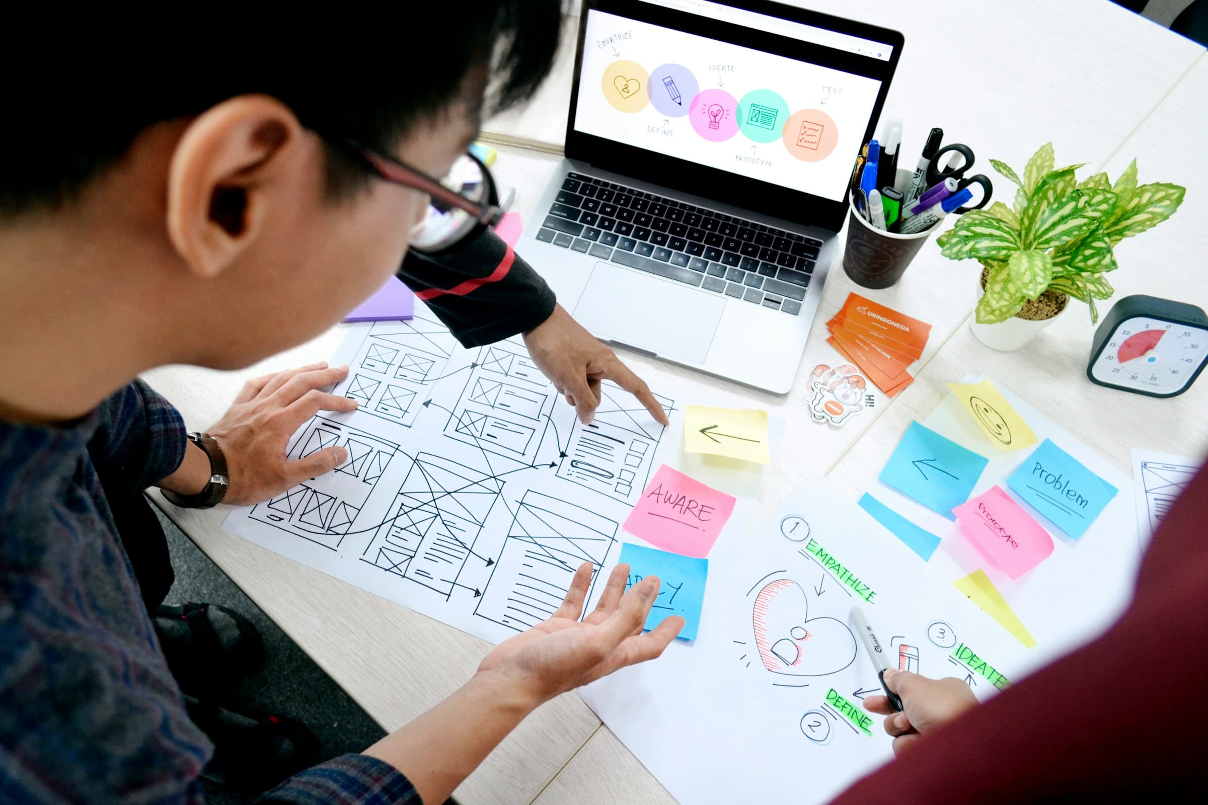 Designer planning website wireframes before estimating development cost