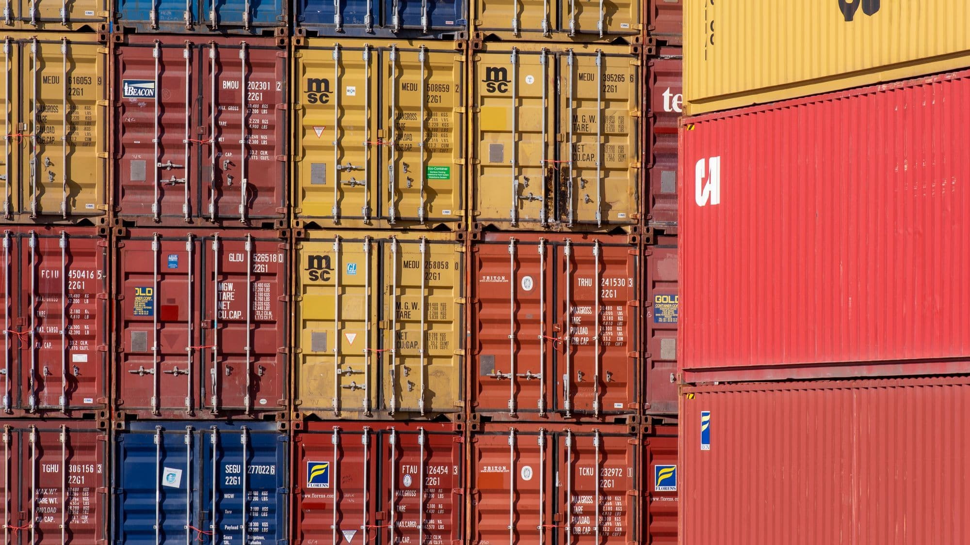 Shipping containers at a port representing Sohar logistics and trading companies