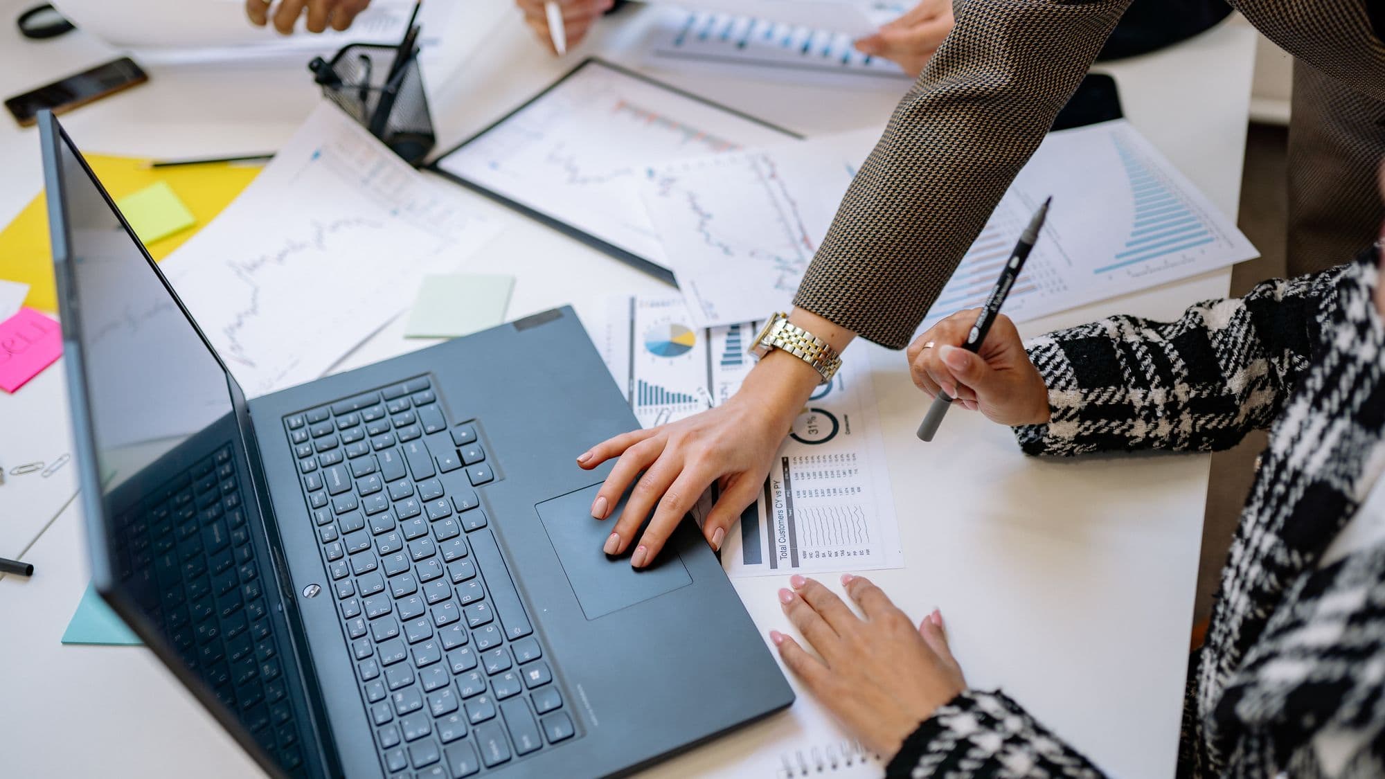 A business team reviewing quotation request information on a laptop