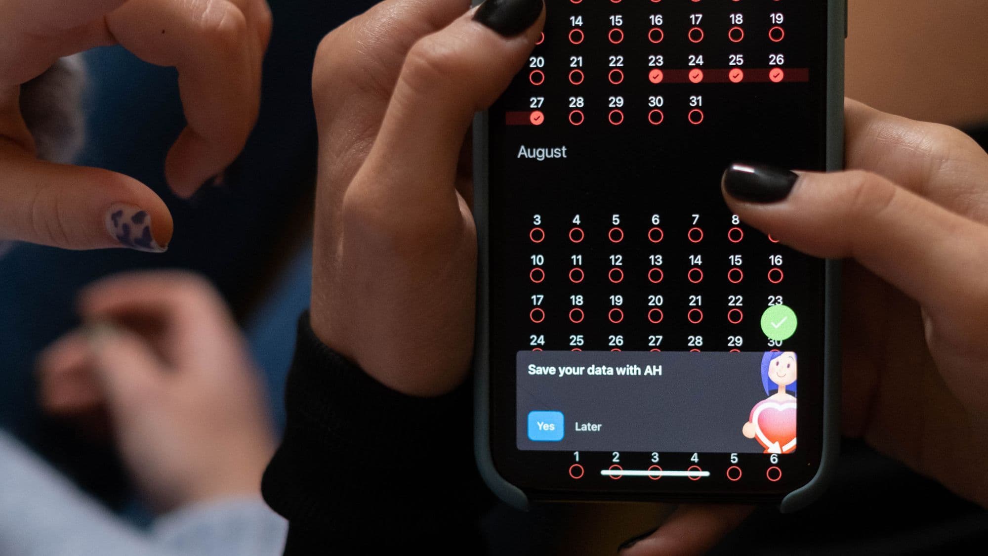 Hands using a digital appointment calendar on a smartphone